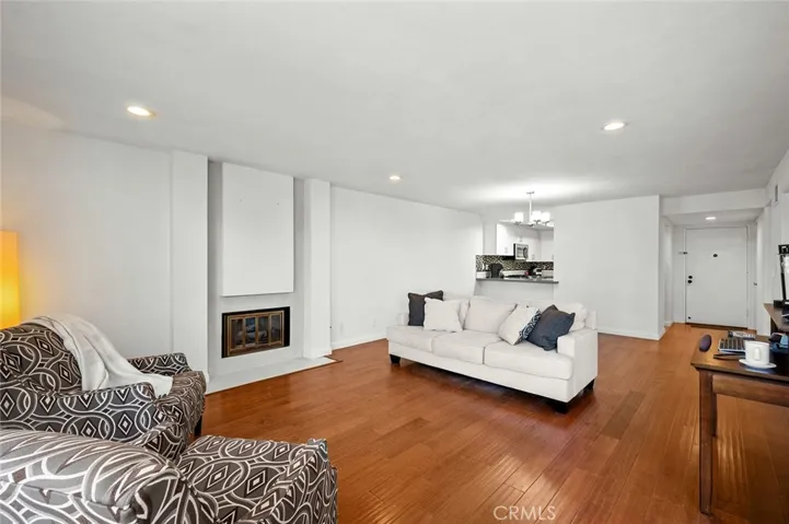Cozy fireplace in the living room. Smooth ceilings and high-end wood flooring.