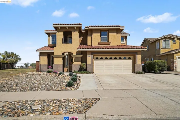 Mediterranean / spanish-style home featuring stucco siding, concrete driveway, a garage, and a tile roof