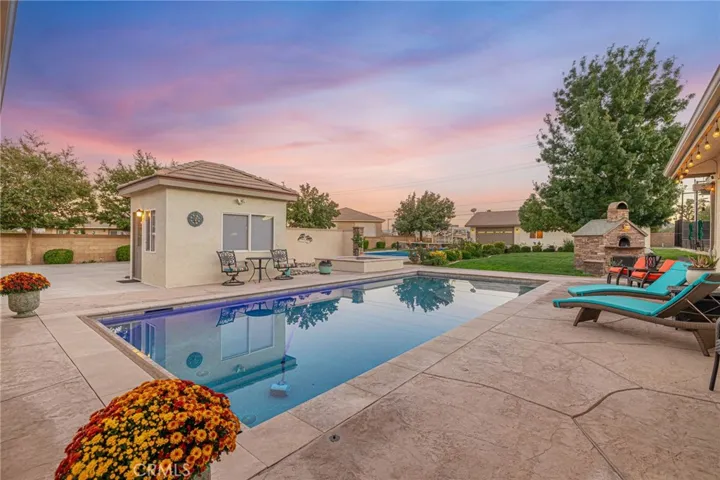 Resort-type rear yard with an in-ground pool and spa.