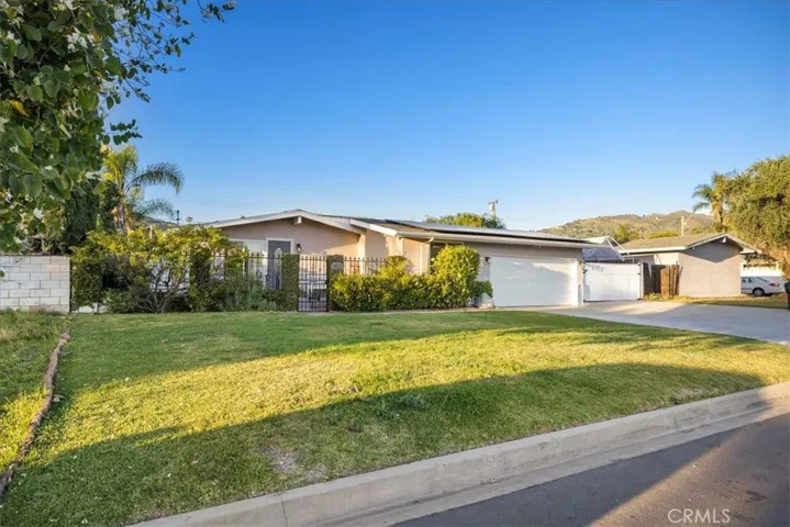 Landscaped yard with automatic sprinklers and a private courtyard.