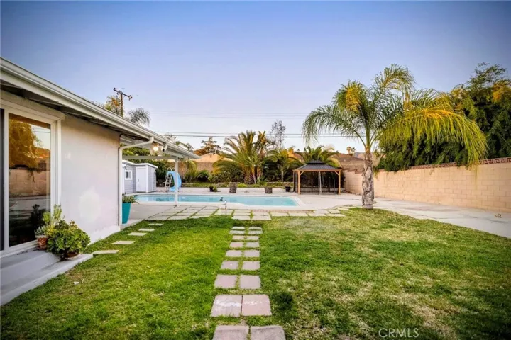 Grassy area and great play area in the backyard. Easy access from the family room, a bedroom & the side gate.
