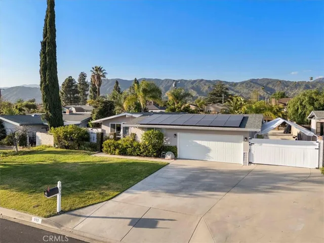 A view of the paid for solar panels and large driveway.