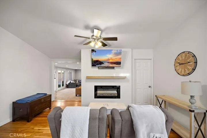 Light and airy living room with an electric fireplace.