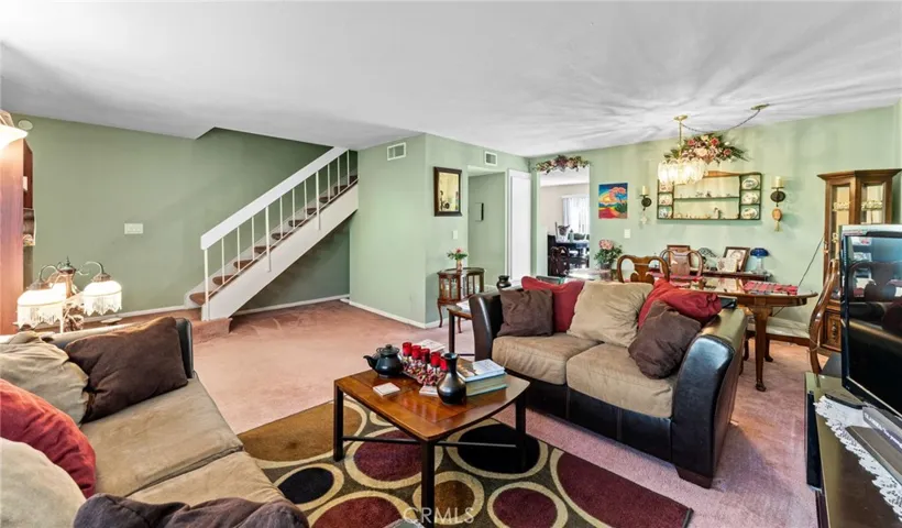 Spacious living room with formal dining area and extra storage under the stairs