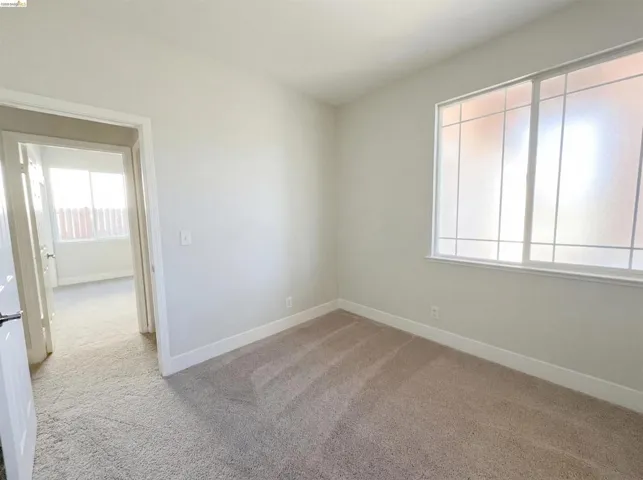 Spare room featuring light carpet