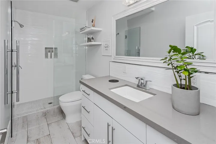 Bathrooms throughout the home are thoughtfully finished with stone countertops, frameless glass-enclosed showers and bathtub-shower combinations, designer lighting, and elegant tile flooring.