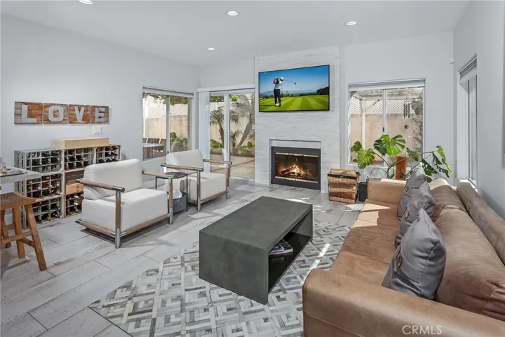 Nearby, the family room centers around a striking feature wall with gas fireplace and a full wet bar with space for a wine refrigerator and bar seating, adding an elevated touch that makes this room perfect for hosting and gathering with friends and family.