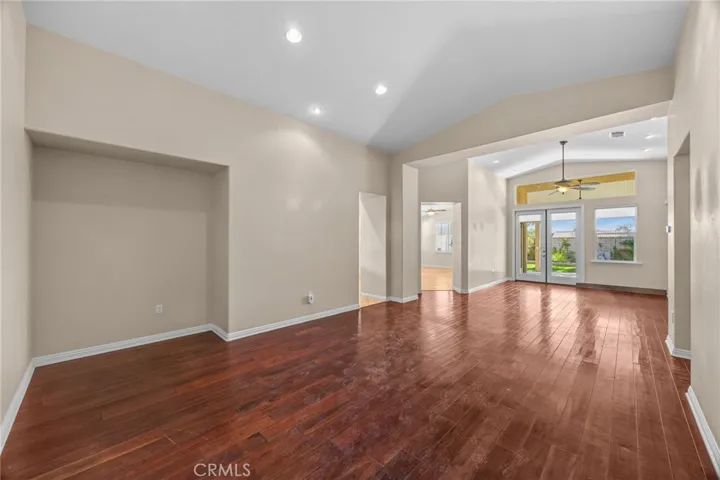 Beautiful hardwood flooring with view to the backyard with fountain
