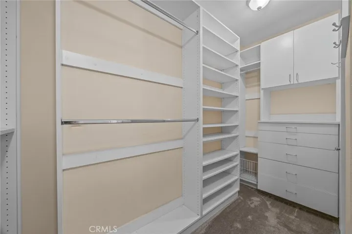 Part of the closet in the primary suite