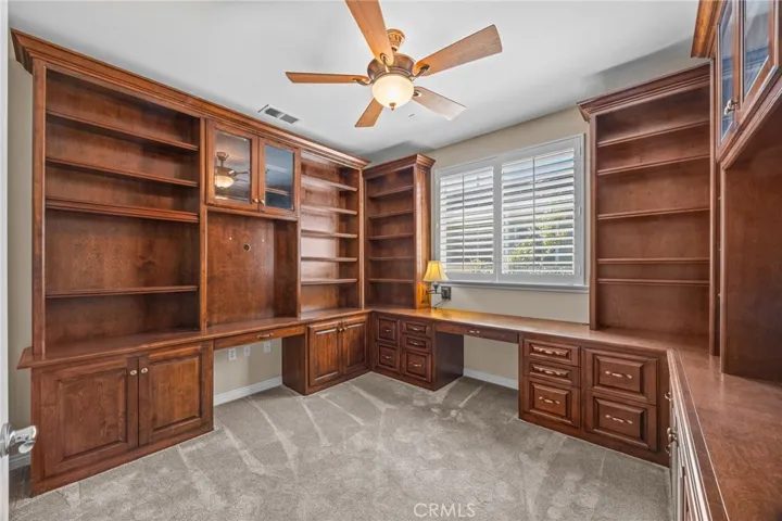 Beautifully done built-in office in one of the bedrooms with closet