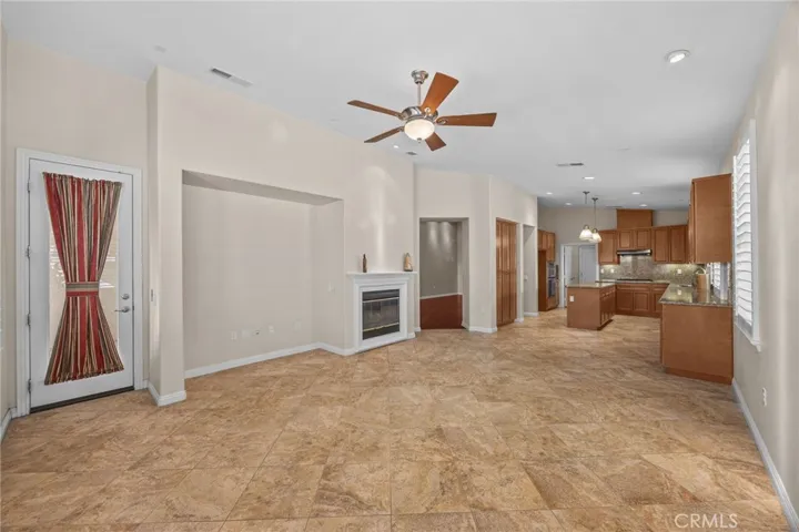 Family room with ceiling fan and fireplace
