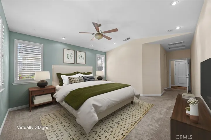 Primary suite virtually staged.  Plantation shutters and ceiling fan are real