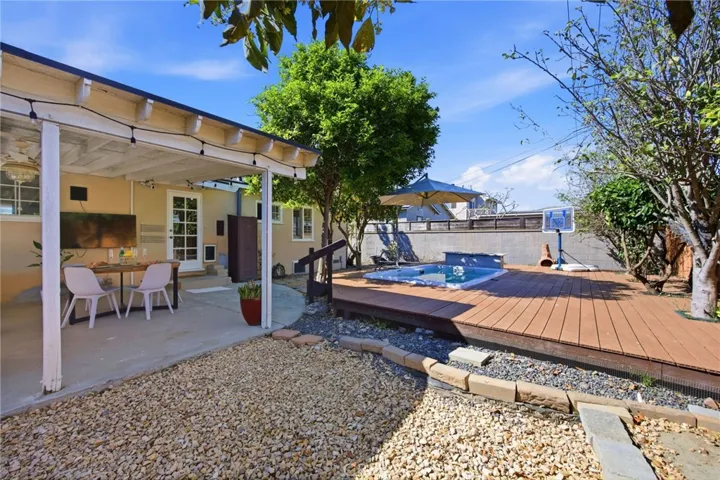 fully-loaded backyard with a SwimSpa, outdoor TV & speakers set within a raised cool-touch composite deck