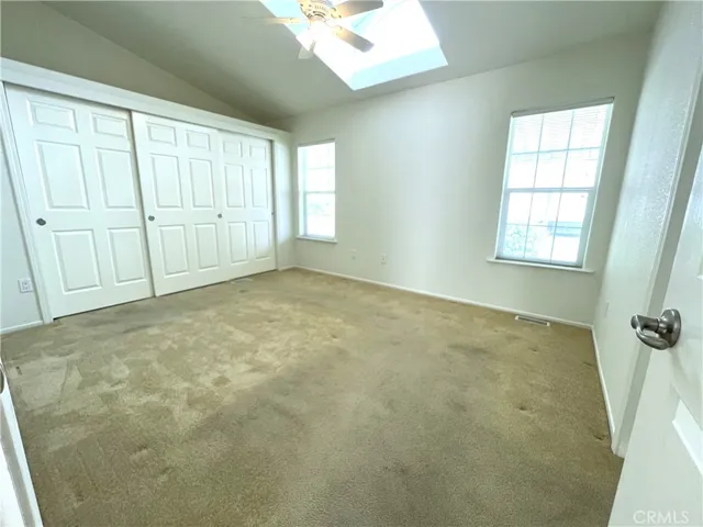 Primary bedroom with a skylight