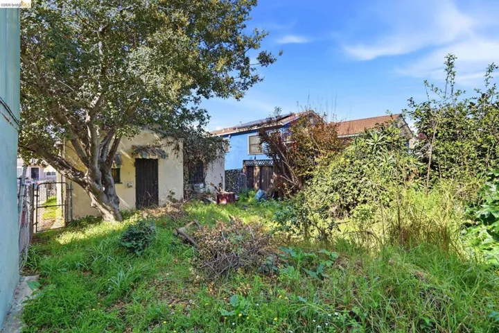 Back of property with stucco siding and a gate