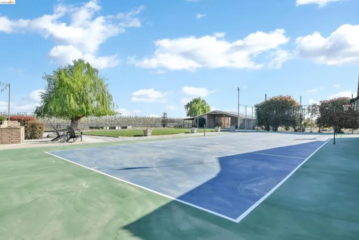 View of tennis court with community basketball court