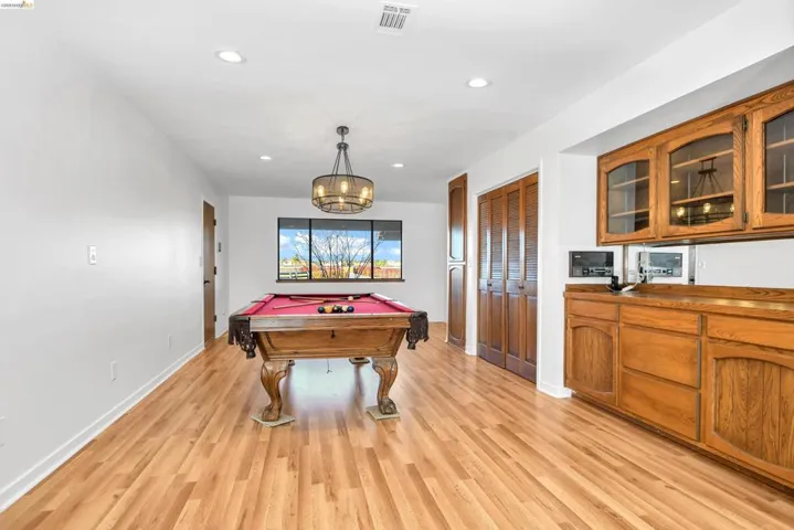 Recreation room with pool table, recessed lighting, and light wood finished floors