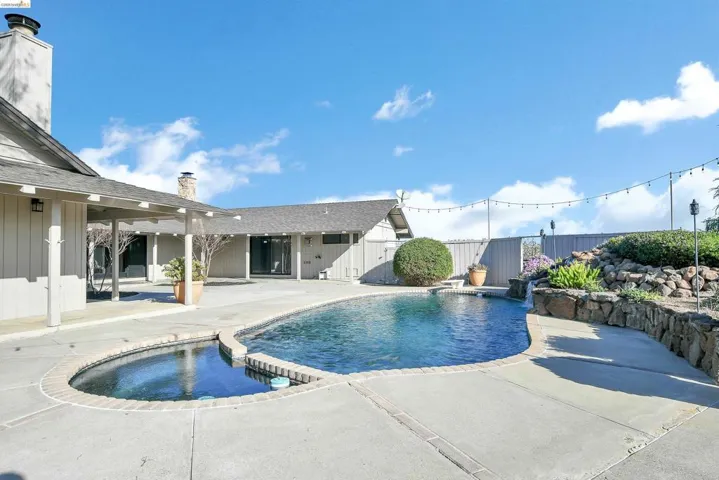 Integrated pool / hot tub with a patio area