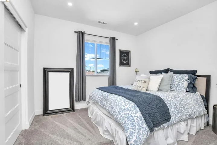 Bedroom featuring light carpet and recessed lighting