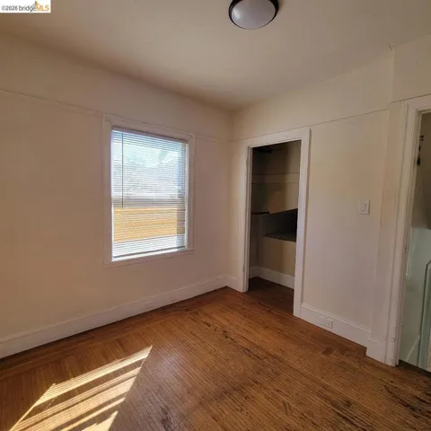 Unfurnished bedroom featuring a closet and hardwood / wood-style flooring