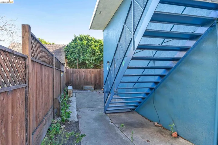 View of side of home with a fenced backyard