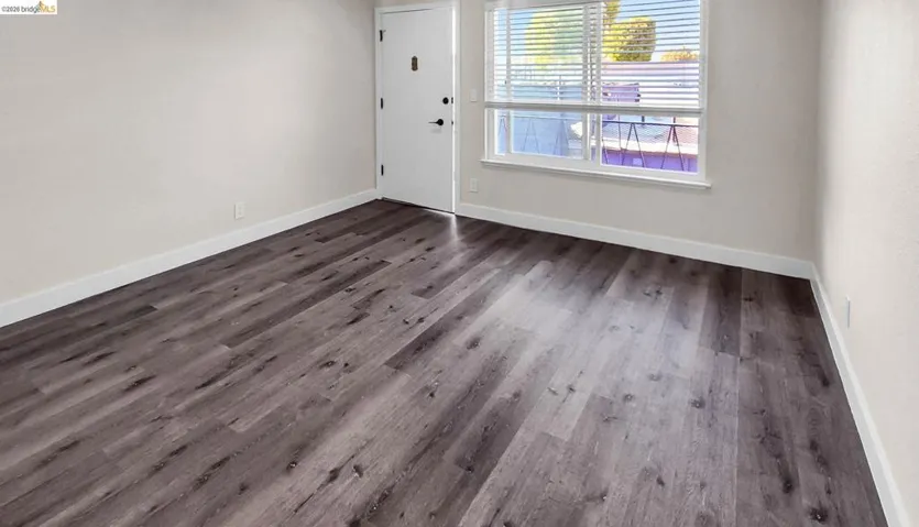 Entryway with baseboards and dark wood-type flooring