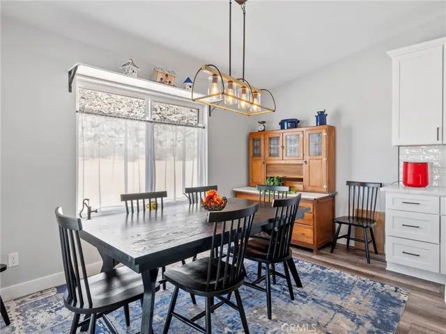 Large dining area off of kitchen with backyard views through picture window