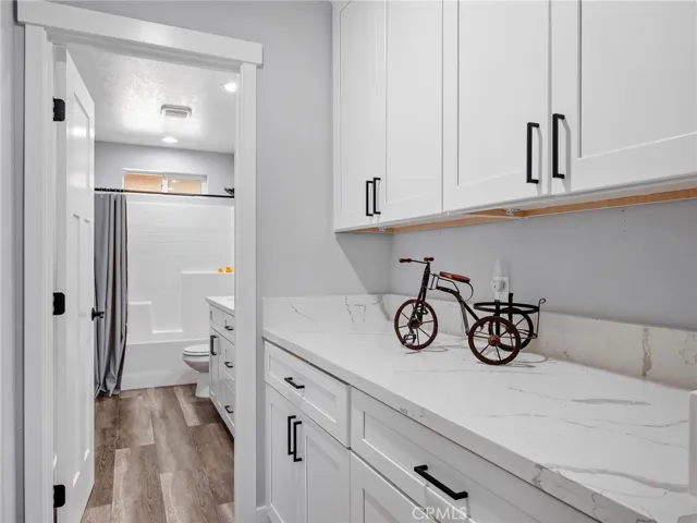 Linen cabinets in hall outside of secondary bath