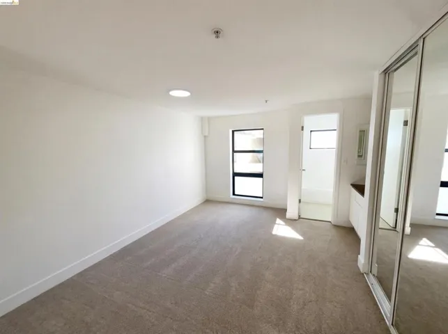 Unfurnished bedroom with a closet and light colored carpet