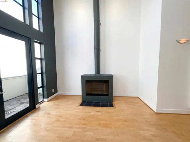 Detailed view of wood finished floors and a wood stove