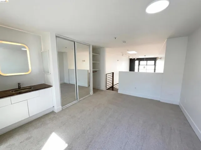 Unfurnished bedroom featuring light colored carpet and a closet