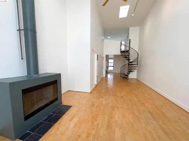 Corridor with a high ceiling and light wood-style flooring