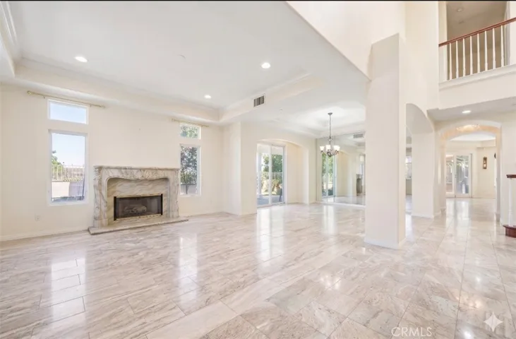 Formal living room w/ fireplace, dining room (Digitally altered)