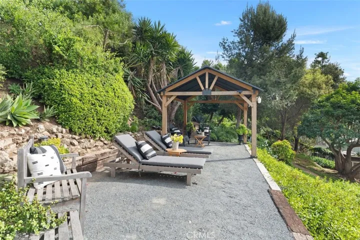 Backyard elevated patio area complete with a pergola.