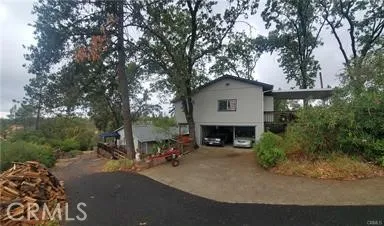View of detached garage with house on left