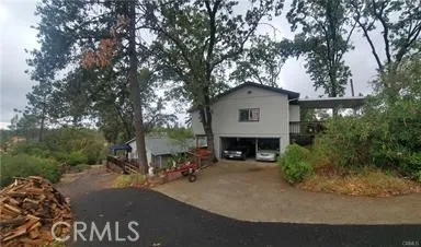 View of detached garage with house on left