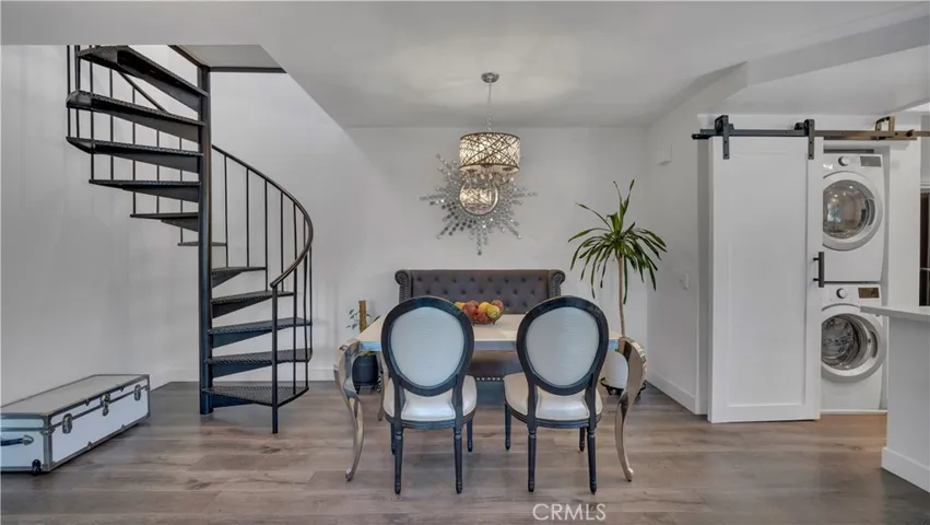 The main living space features beautiful laminate flooring and an airy layout connecting 
the living, dining and kitchen areas. Spiral staircase leads to 2nd bedroom/loft.