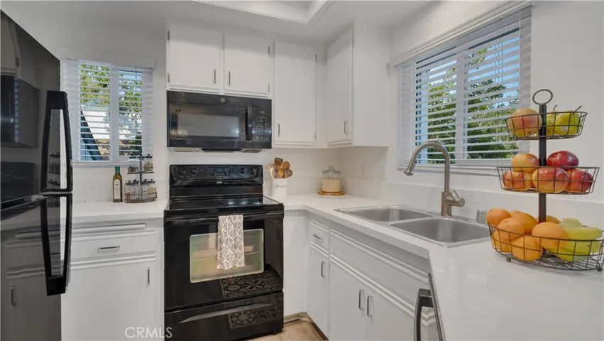 The updated kitchen shines with quartz countertops and newer appliances, creating a modern space that feels both functional and inviting.
