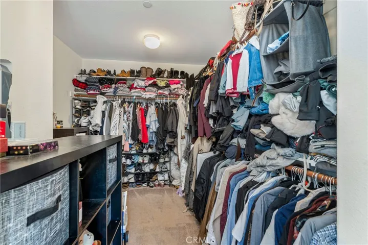 upstairs primary bedroom walk in closet.
