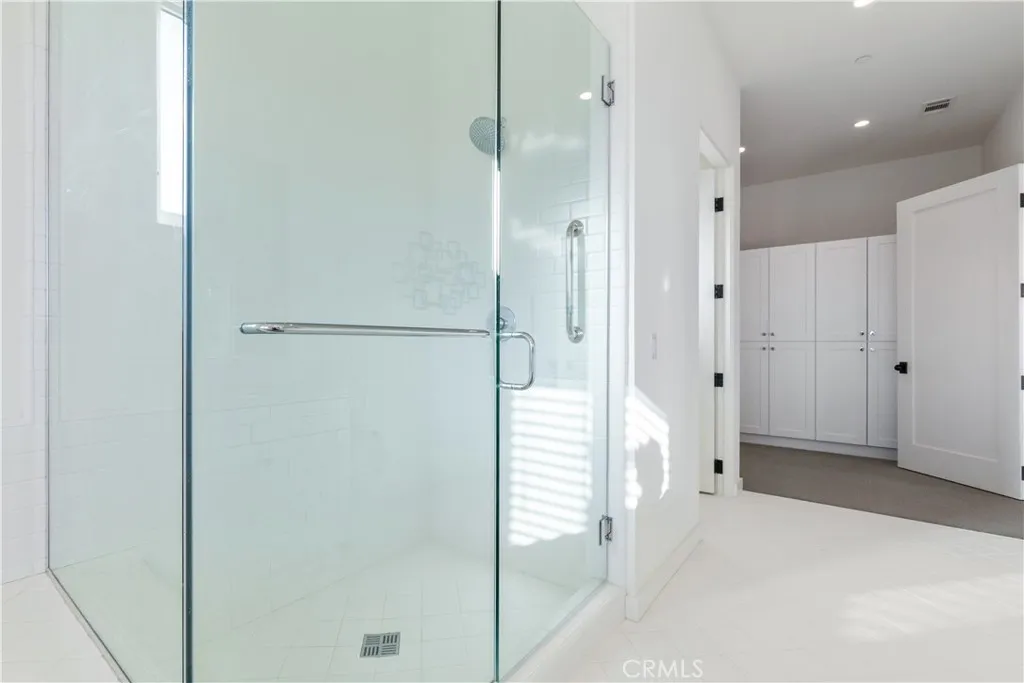 Formal dressing room inside expansive primary bathroom