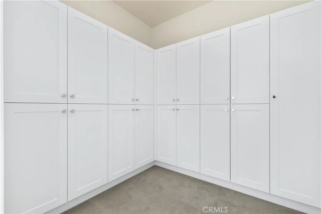 Dressing room with built ins just as you head towards primary bathroom. HUGE primary suite with spa like bathroom.