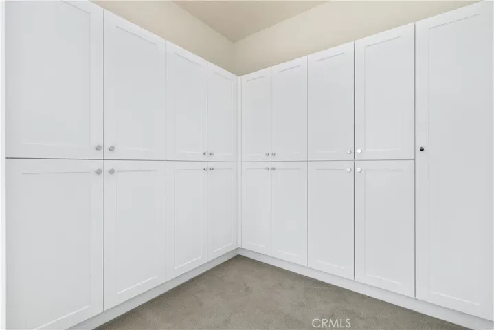 Dressing room with built ins just as you head towards primary bathroom. HUGE primary suite with spa like bathroom.