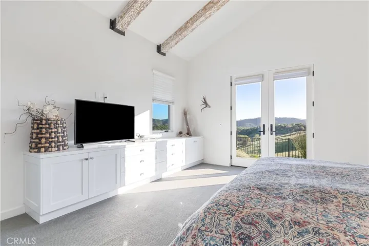 Primary suite with stunning coastal mountain range views .