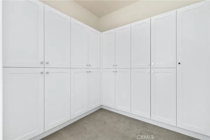 Dressing room with built ins just as you head towards primary bathroom. HUGE primary suite with spa like bathroom.