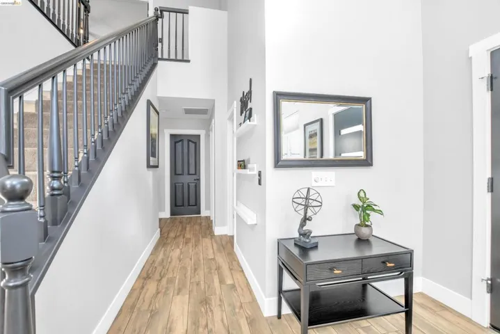 Foyer featuring light wood-type flooring and a high ceiling
