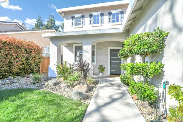 View of exterior entry featuring stucco siding and a porch