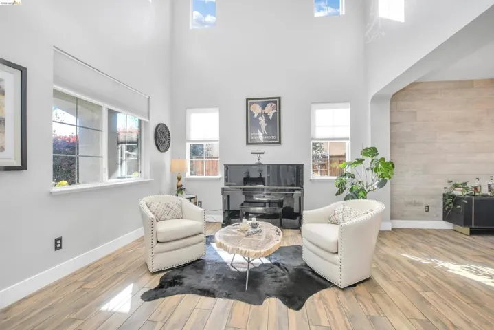 Living area with wood finished floors and a high ceiling