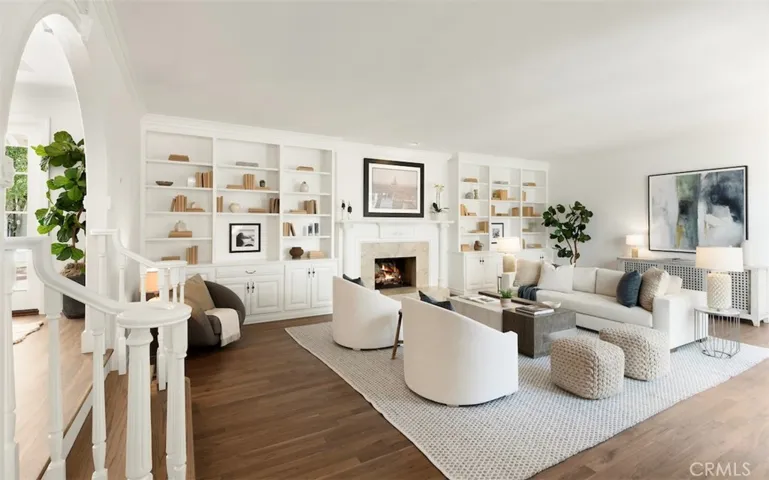 Living room with wood burning fireplace and walnut hardwood floors