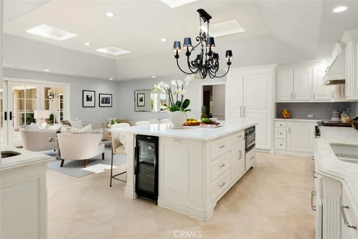 Dream open concept kitchen featuring center island with Calacutta marble counters and high end appliances. 4 skylights with lights for night time ambience.