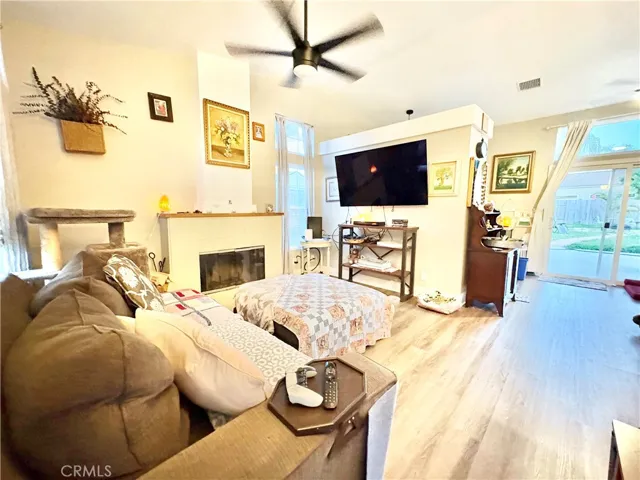 LIVING ROOM WITH COZY FIREPLACE, NEW WINDOWS, HIGH CEILINGS & LAMINATE FLOORING